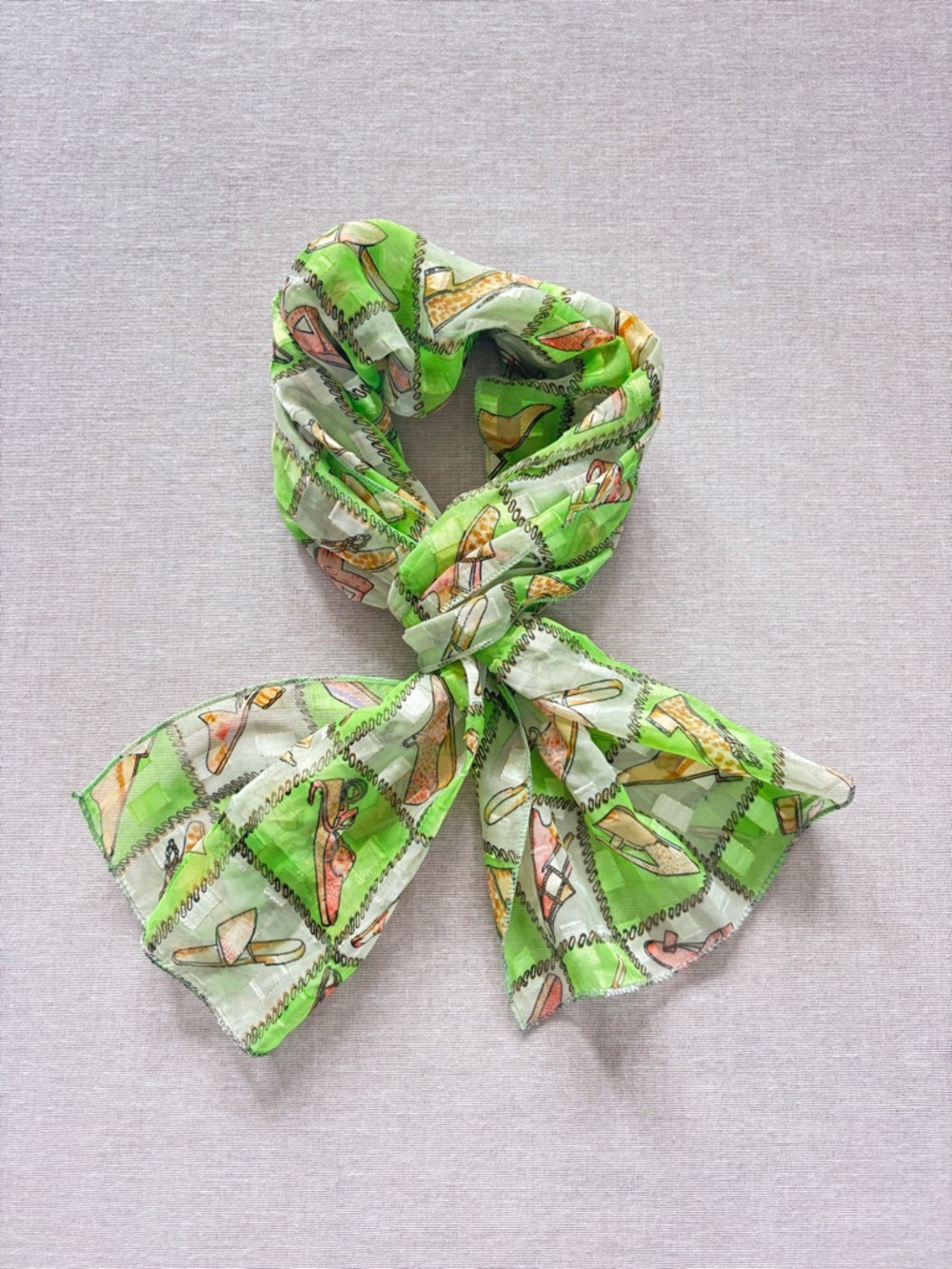 Sheer green shoe print scarf.